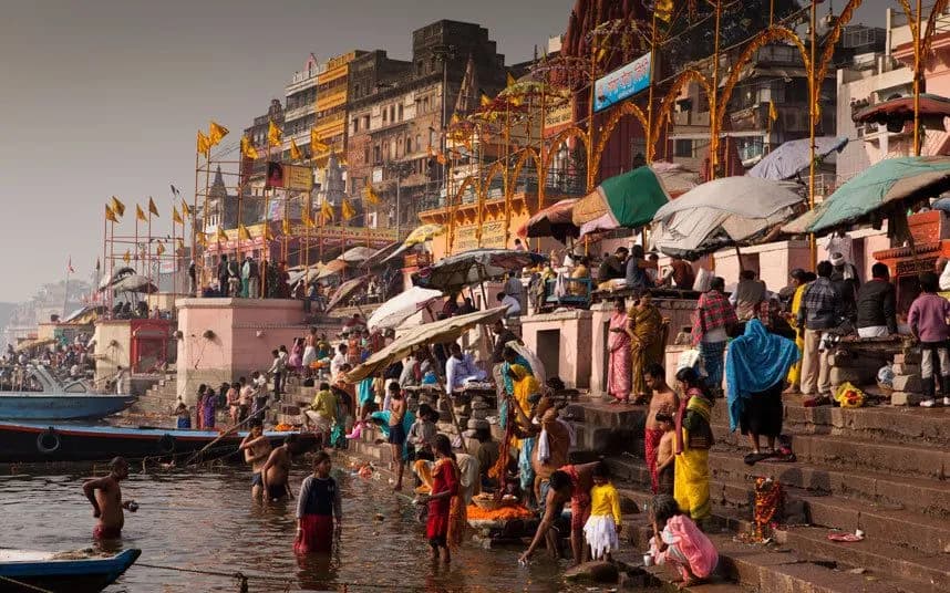 Crowds of pilgrims on the colourful ghats of Varanasi beside the Ganga