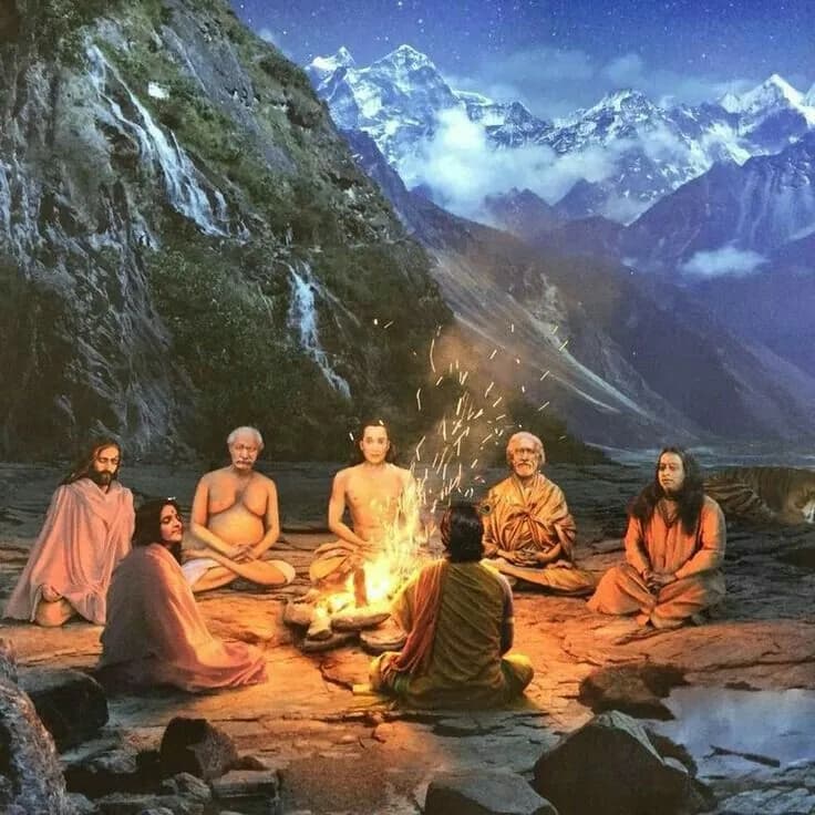Sadhus seated around a sacred fire beside a waterfall with snowy peaks behind